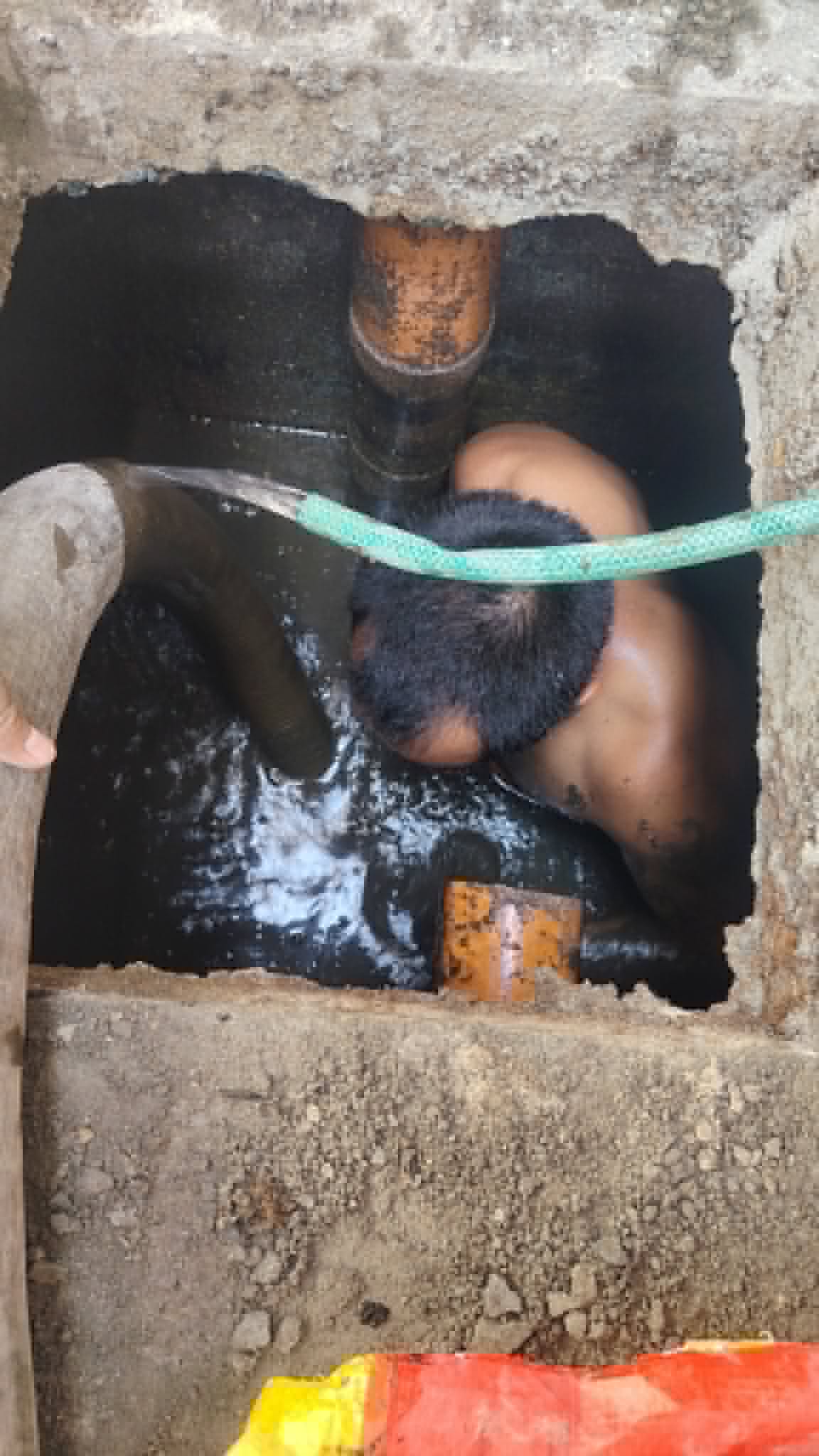 Hand clearing a septic line by touch